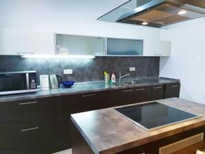 a kitchen with a sink and a microwave at A&M Apartment Donovaly in Donovaly