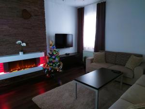 a living room with a christmas tree and a fireplace at A&M Apartment Donovaly in Donovaly