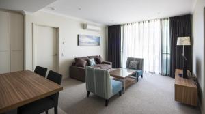 a living room filled with furniture and a large window at Mantra Geraldton in Geraldton