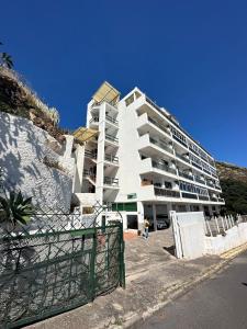 a large white apartment building on the side of a hill at Apto boca cangrejo Netflix,parking,aire acondicionado y rent car in Santa Cruz de Tenerife