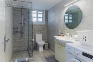 a bathroom with a shower and a toilet and a sink at P&K LUXURY APARTMENTS 2 in Kalamata