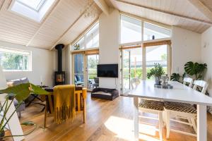 a living room with a table and some chairs at Modern and cozy cabin near Copenhagen city and airport in Dragør