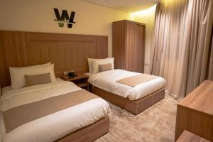 a hotel room with two beds in a room at W Suites Hotel in Abha