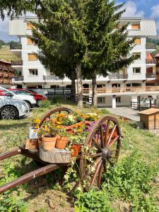 un vecchio carro con fiori e piante sopra di Hotel Hermitage a Sestriere