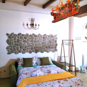 a bedroom with a bed with a large rock wall at Casa Francesco in Forza dʼAgro