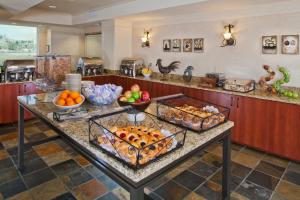 a kitchen with a table filled with fruits and vegetables at Silver Cloud Hotel - Seattle Lake Union in Seattle