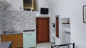 a small kitchen with a sink and a stove at MINI HOUSE in Montescaglioso