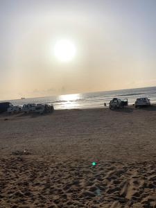 a group of cars parked on the beach at Appartement youssef in Agadir