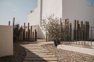 a walkway in front of a building with a fence at room Select Tetuán in Seville