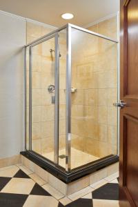a shower with a glass door in a bathroom at The Battle House Renaissance Mobile Hotel & Spa in Mobile
