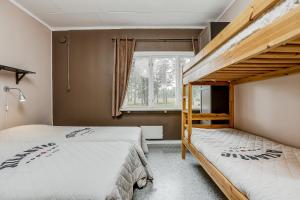 a bedroom with two bunk beds and a window at STF Hostel Lärbro/Grannen in Lärbro