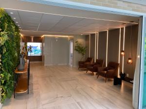 a lobby with a waiting room with chairs at Promenade II PONTA VERDE in Maceió