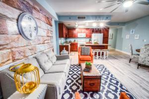 a living room with a couch and a clock on a wall at Laketown Wharf Resort 416 By Aneliya in Panama City Beach