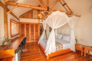 a bedroom with a bed with a mosquito net at Komodo Resort in Sebayur