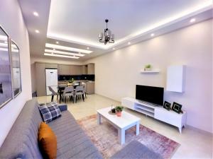 a living room with a couch and a table at Flat with Shared Pool and Backyard in Alanya in Avsallar