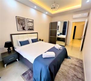 a bedroom with a large bed with two towels on it at Flat with Shared Pool and Backyard in Alanya in Avsallar