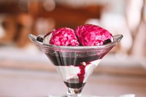two pink ice cream balls in a glass dish at Хотел Феникс in Chepelare