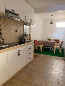 a kitchen with a table and a dining room at Appartement youssef in Agadir