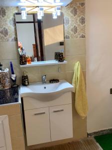 a bathroom with a sink and a mirror at Appartement youssef in Agadir