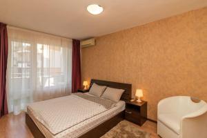 a bedroom with a bed and a window at Niko's 2 Bedroom Central Apartment in Sofia