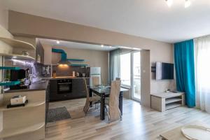 a kitchen and dining room with a table in a room at Niko's 2 Bedroom Central Apartment in Sofia