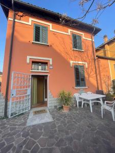 a orange building with a table and a white table at Piana, Bologna by Short Holidays in Bologna