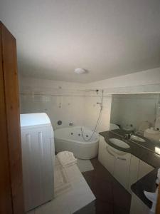 a bathroom with a sink and a toilet and a tub at Piana, Bologna by Short Holidays in Bologna
