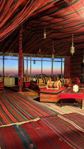 a living room with couches and tables in a building at Rocky Mountain Hotel in Wadi Musa