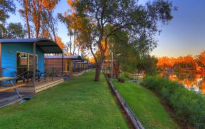 a house on the side of a river at BIG4 Deniliquin Holiday Park in Deniliquin