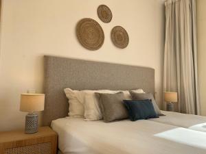 a bedroom with a bed with two hats on the wall at Pestana Palm Gardens in Carvoeiro