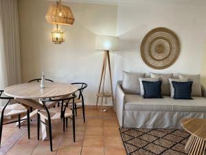a living room with a couch and a table at Pestana Palm Gardens in Carvoeiro