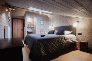 ein Schlafzimmer mit einem großen Bett und einem Tisch in der Unterkunft La Maison du Marcel in Sainte-Cécile
