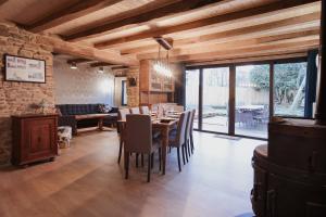 a dining room with a table and some chairs at La Maison du Marcel in Sainte-Cécile