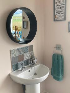 a bathroom with a sink and a mirror at The Loft - Shemara 