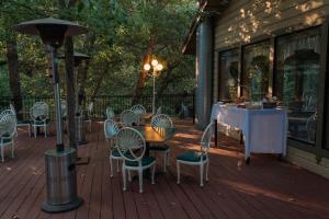 a patio with a table and chairs on a deck at Northern Queen Inn in Nevada City