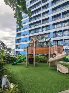 a playground in front of a large building at Happirest at SMDC Air Residences Makati in Manila