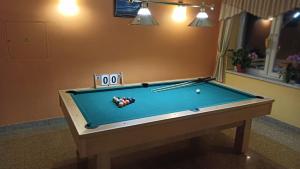 a pool table with billiard balls and cues on it at Penzion Adak in Párnica