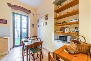 a kitchen and dining room with a table and chairs at Florence Quiet Apartment with Private Garden in Florence