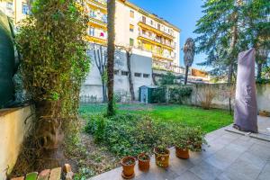 a yard with potted plants and a building at Florence Quiet Apartment with Private Garden in Florence