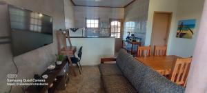 a living room with a couch and a wooden table at Casa das Conchas Búzios in Búzios