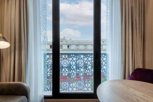 a room with a window with a view of a building at Querencia de Sevilla, Autograph Collection in Seville
