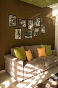 a living room with a couch and pictures on the wall at La Conchiglia Case Vacanze in Balestrate