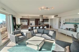 een woonkamer met 2 banken en een keuken bij Luxury Monaco Sea View Penthouse Le Lord in Beausoleil