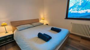a bedroom with a bed with two bags on it at Appartamento panoramico in Sùtrio
