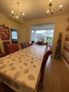 a dining room with a table and a christmas tree at Blackpool Abode - Caxton Lodge in Blackpool