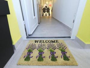 a welcome mat in front of a door with a welcome sign at Apartment Gaby in Božava