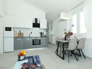a kitchen with a table and chairs in a room at Apartment Gaby in Božava