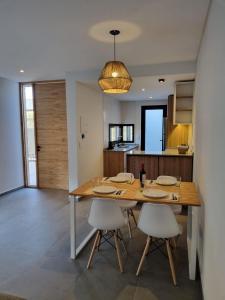 a dining room with a wooden table and chairs at Villa Las Moras in Ciudad Lujan de Cuyo