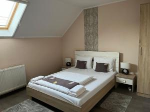 a bedroom with a large bed and a window at Matyas Vendeghaz in Sovata +57 photos