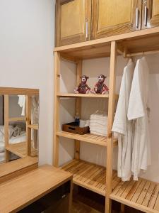 a closet with wooden shelves and white towels at En nho Homestay SaPa in Sapa